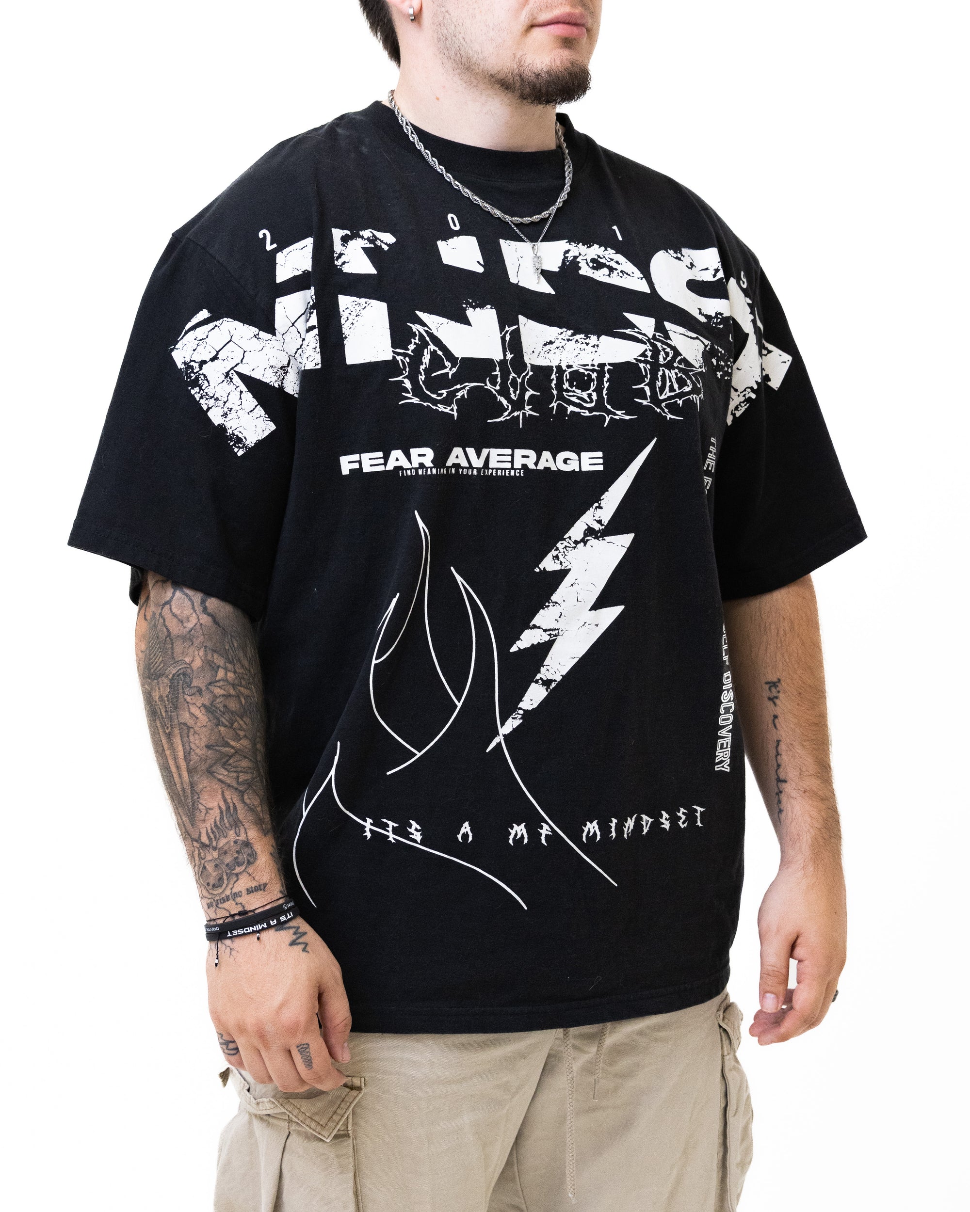 Person wearing a black t-shirt with white graphics and text