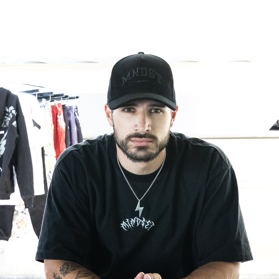 MNDST Model wearing the Revelations Tee and Phantom Cap.