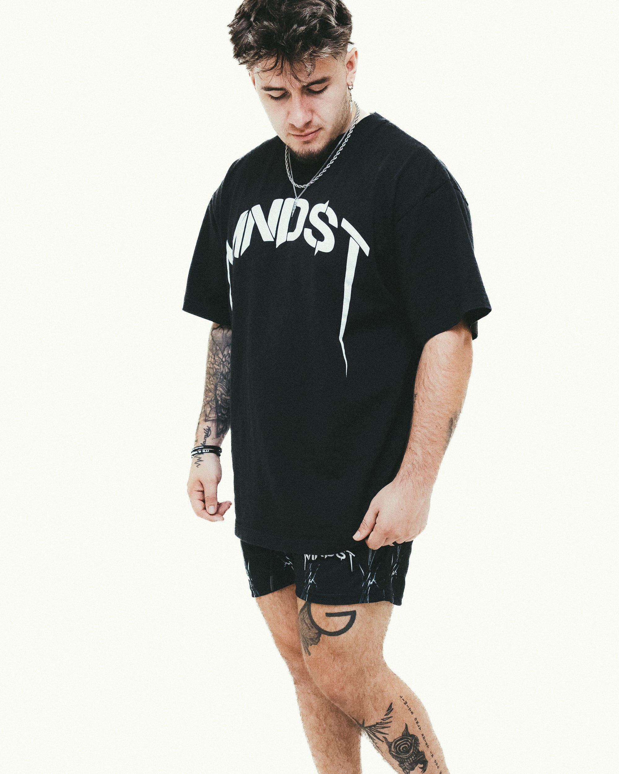 Person wearing a black t-shirt with white text on a white background
